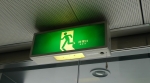 Japanese green exit sign with Running Man moving to the left through a doorway
